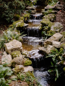 A tranquil outdoor area with natural stone and flowing water, perfect for relaxation.