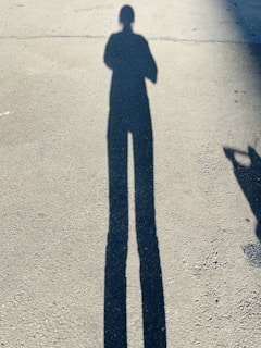 Concrete foundation being laid early morning with sunlight casting long shadows.