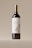 A wine bottle with a sleek and elegant design is centered against a neutral background. The label features an illustration of an owl, adding a touch of artistic charm, and prominently displays the text 'An Elegant Wine.' The bottle has a dark body with a shiny metallic gold cap.