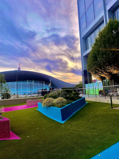 A vibrant residential garden in Monterrey featuring freshly installed synthetic grass with children playing.