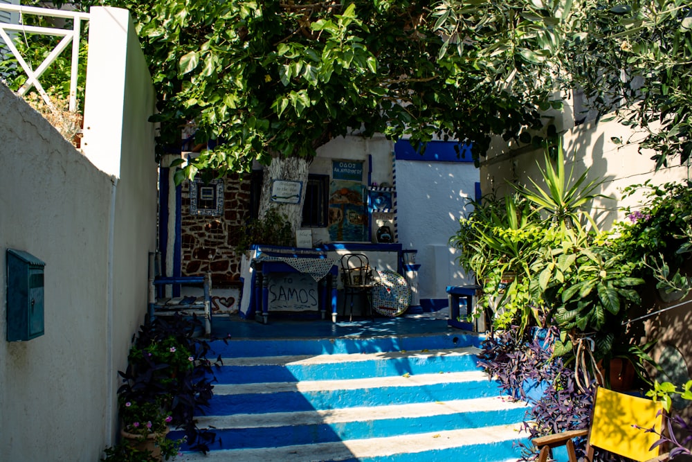 a blue and white staircase leading up to a house