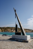 a statue of a person holding a cross