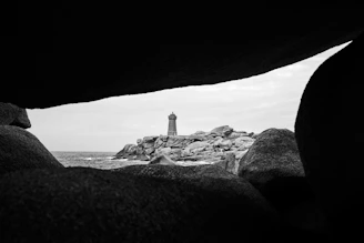 An elegant black and white art print of a vintage lighthouse, matted and ready to hang.