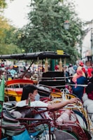 a group of people riding on top of a cart