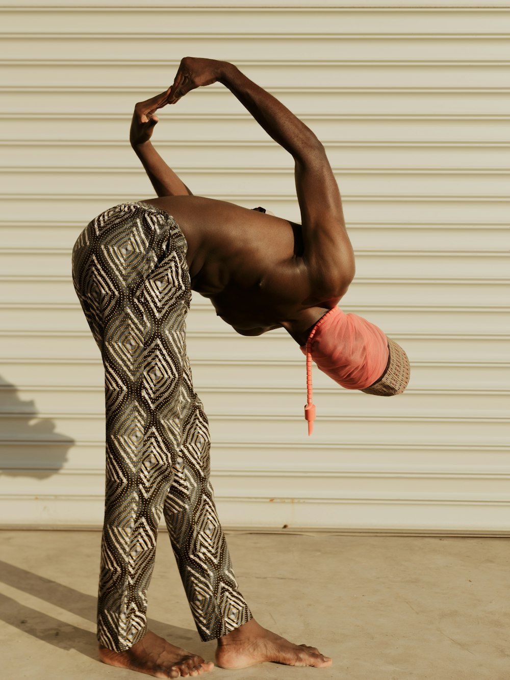 a man doing a handstand in front of a garage door