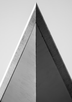 Sharp, angular architectural detail in monochrome tones emphasizing precision and control.