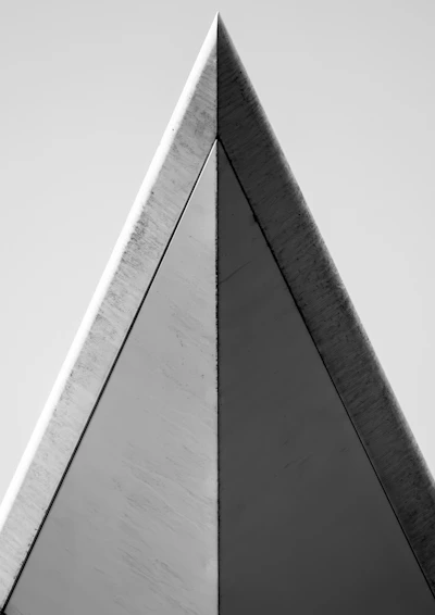 Monochrome architectural detail showcasing sharp lines and deep shadows against a matte black background.