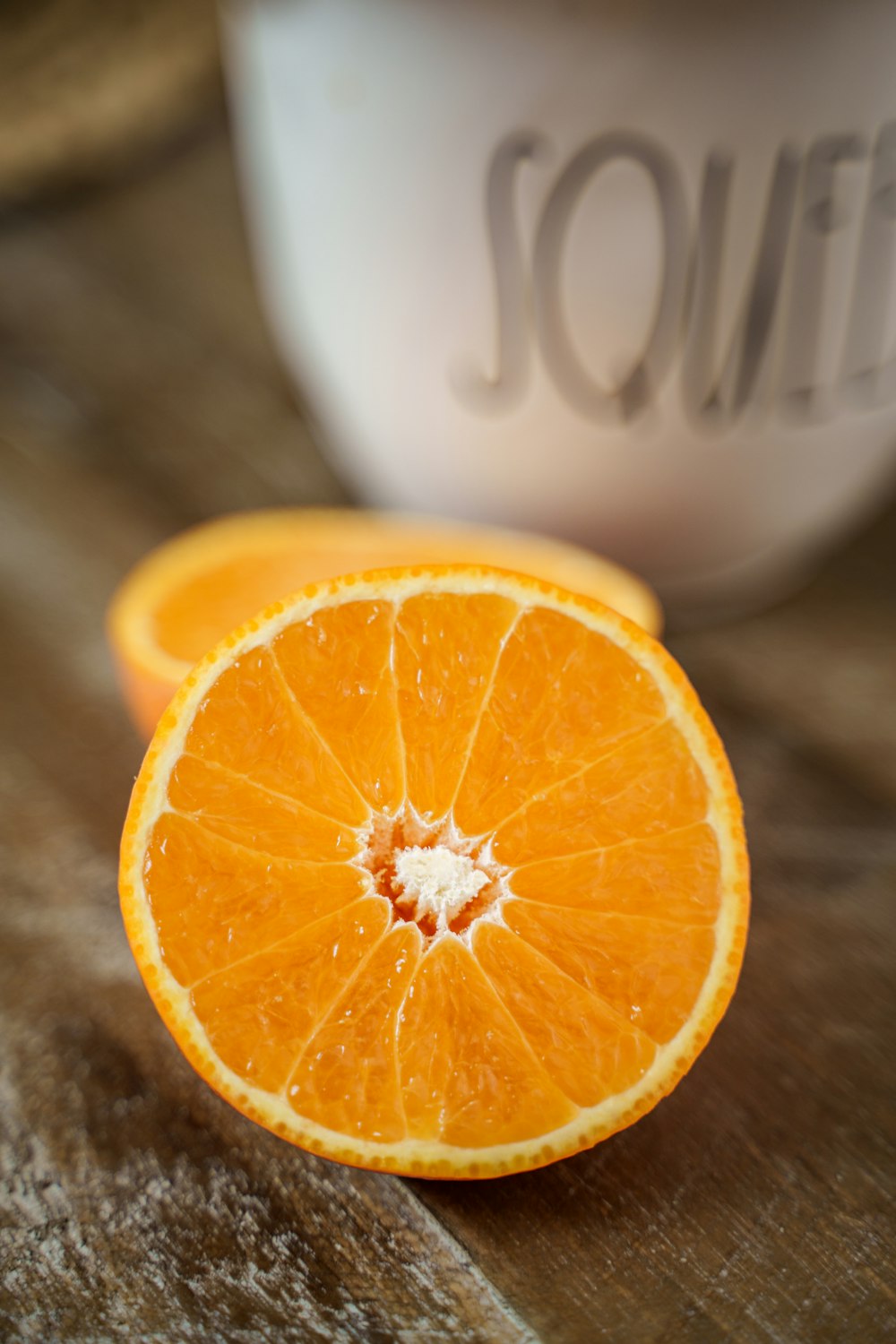 an orange cut in half sitting on a table