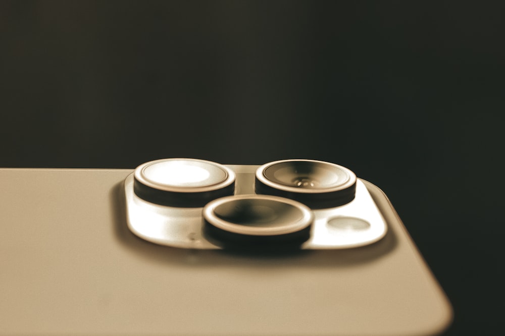 a close up of a plate with three bowls on it