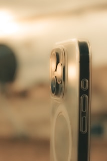 A close-up of a smartphone with a protective tempered glass screen guard applied.