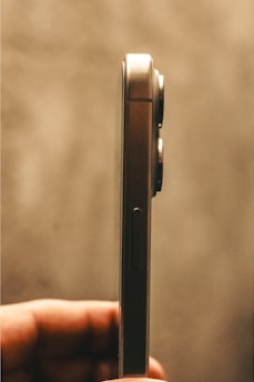 Close-up photo of a mini smartphone being tested in a hands-on review.