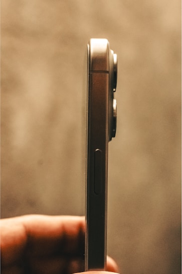 A close-up of a sleek new smartphone held in hand, showcasing its vibrant display and smooth design.