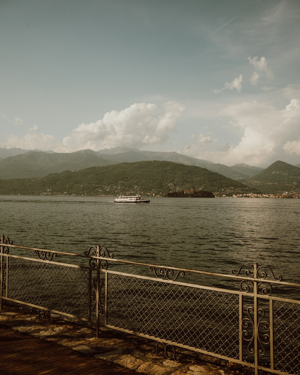 a large body of water with a boat in the distance