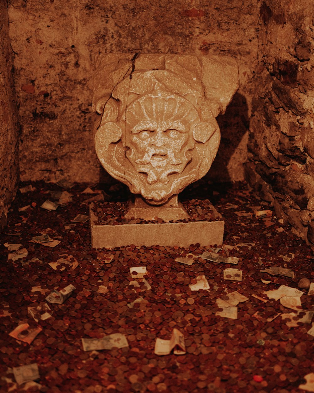 a statue of a lion surrounded by coins