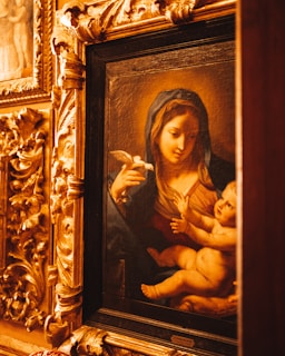 A peaceful image of the Virgin Mary with the infant Jesus, rendered in delicate Renaissance brushwork.