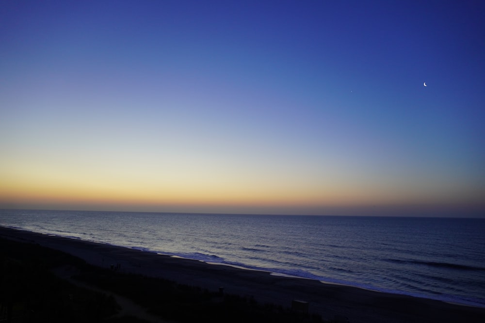 a view of the ocean at sunset from a balcony