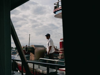a man standing on the deck of a boat