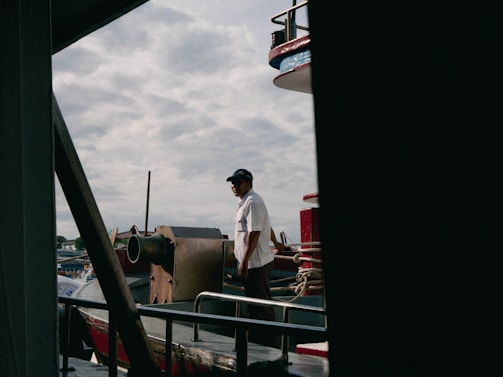 a man standing on the deck of a boat