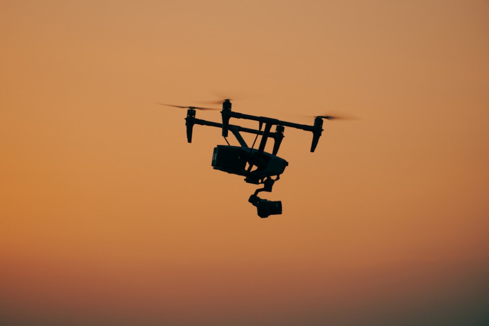 a small airplane flying through a sunset sky