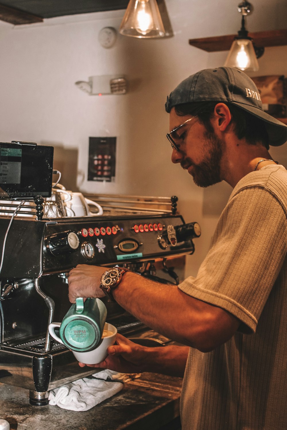 a man pouring a cup of coffee into a machine