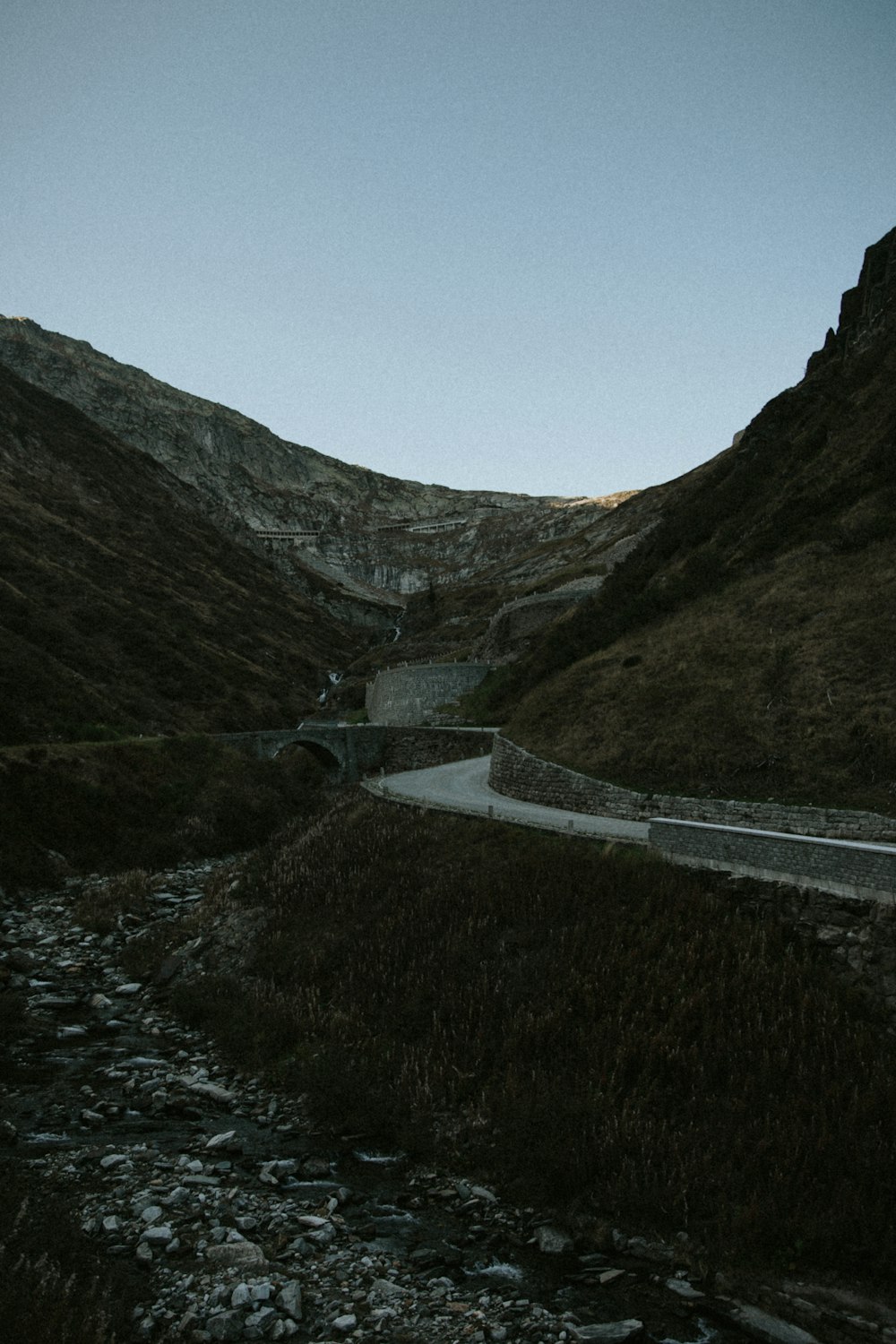 a road going through a valley with a mountain in the background