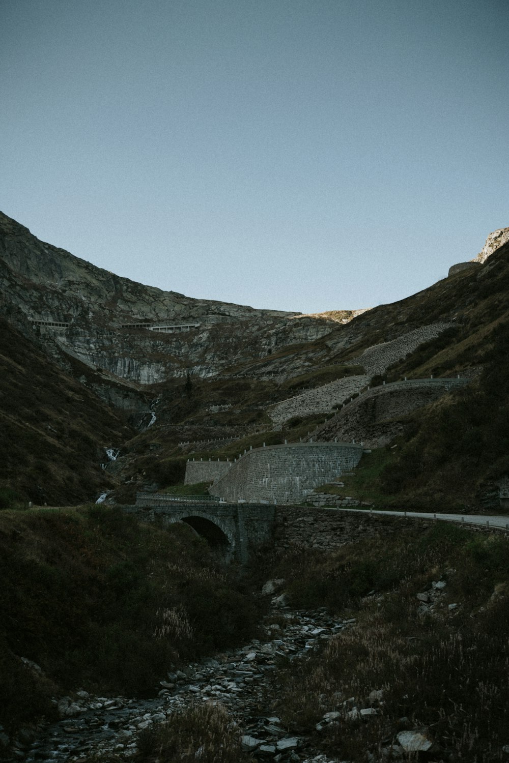 a road going through a valley with mountains in the background