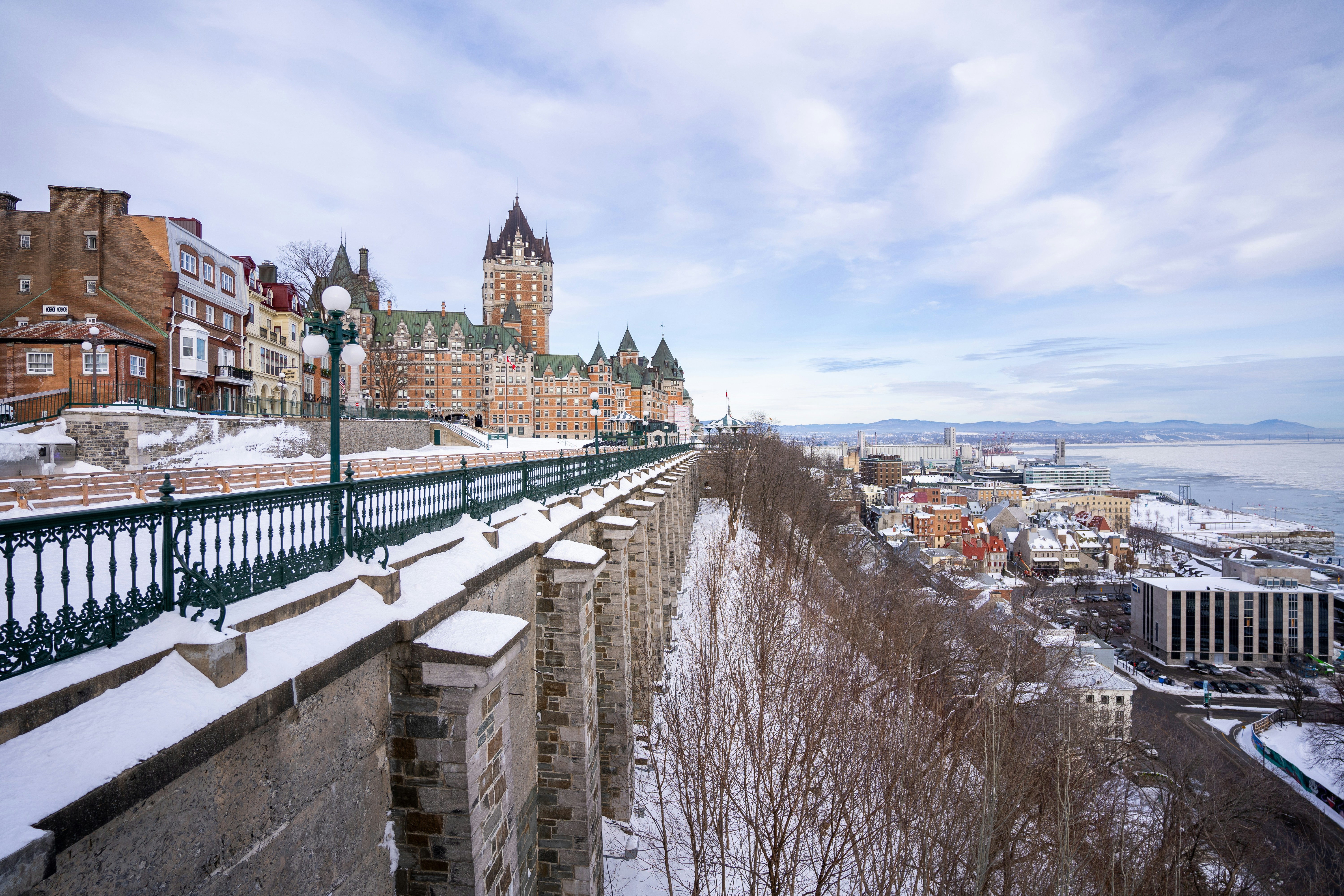 a view of a snow covered city from a bridge, 