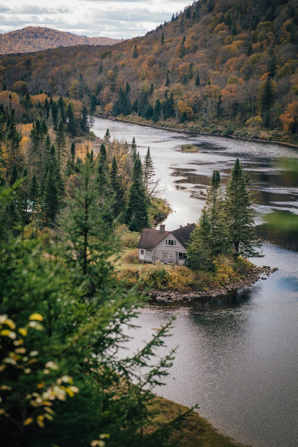 a house on a small island in the middle of a lake