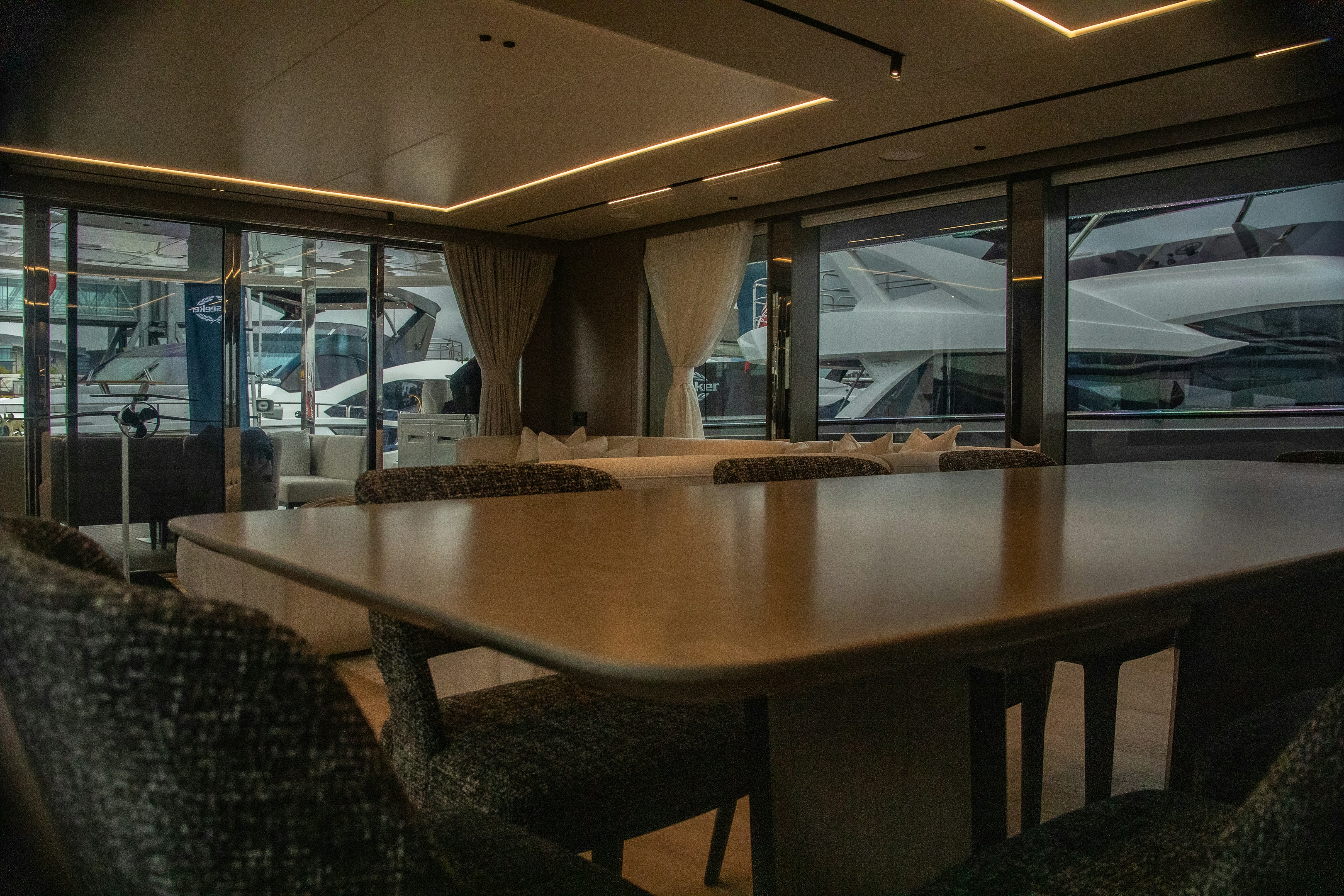 Large wooden boardroom table with city skyline backdrop