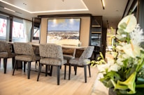 Elegant dining set displayed in a bright, modern room.