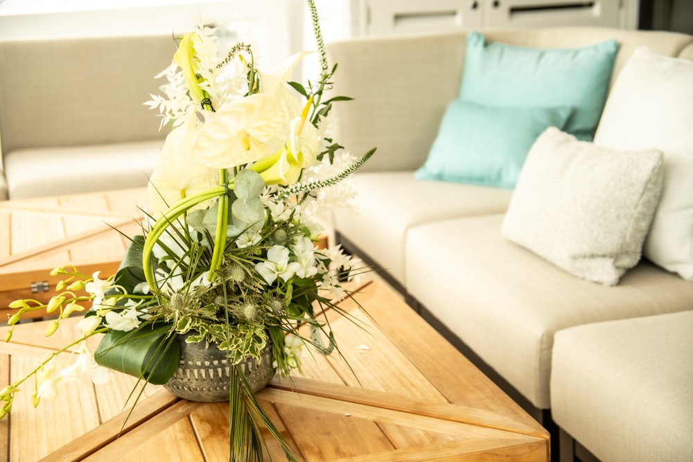 a table with a vase of flowers on top of it