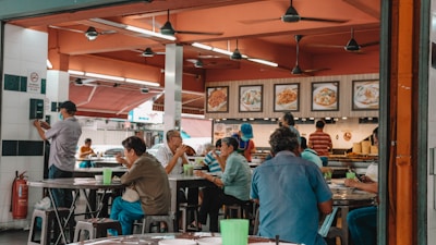 A group of friends enjoying a meal together at a vibrant food court.