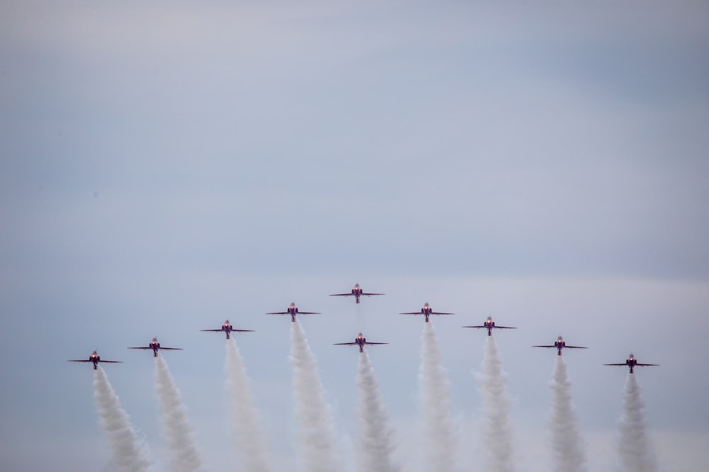 a group of planes flying in formation in the sky