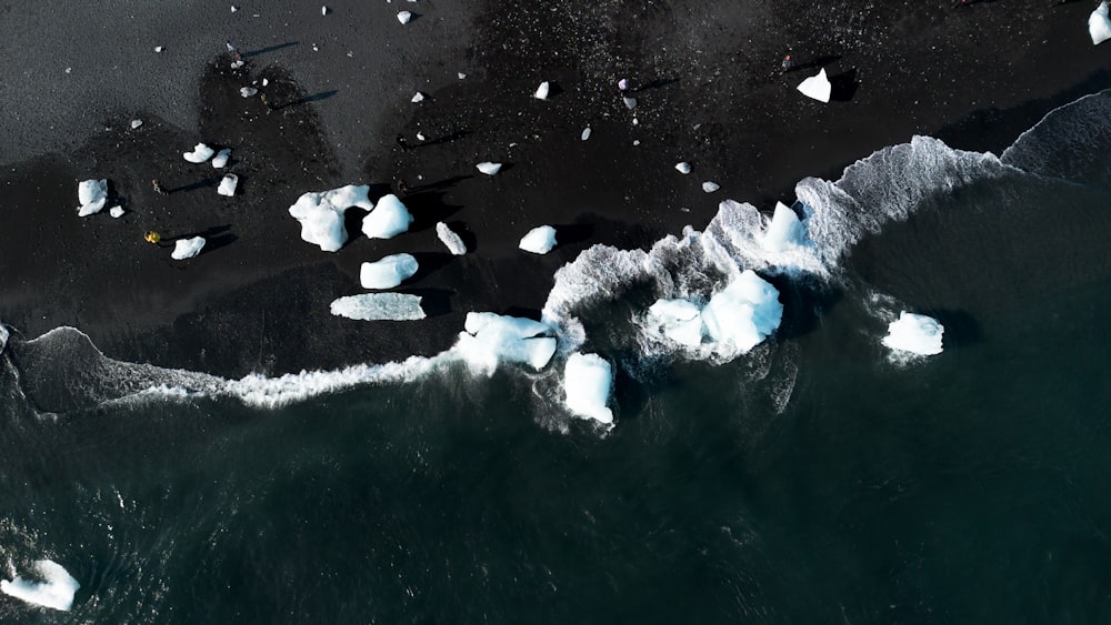 an aerial view of icebergs floating in the water