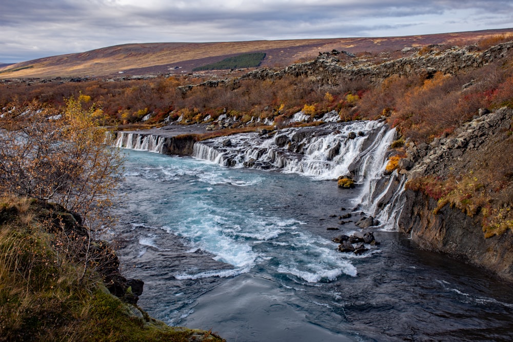 a small waterfall in the middle of a river