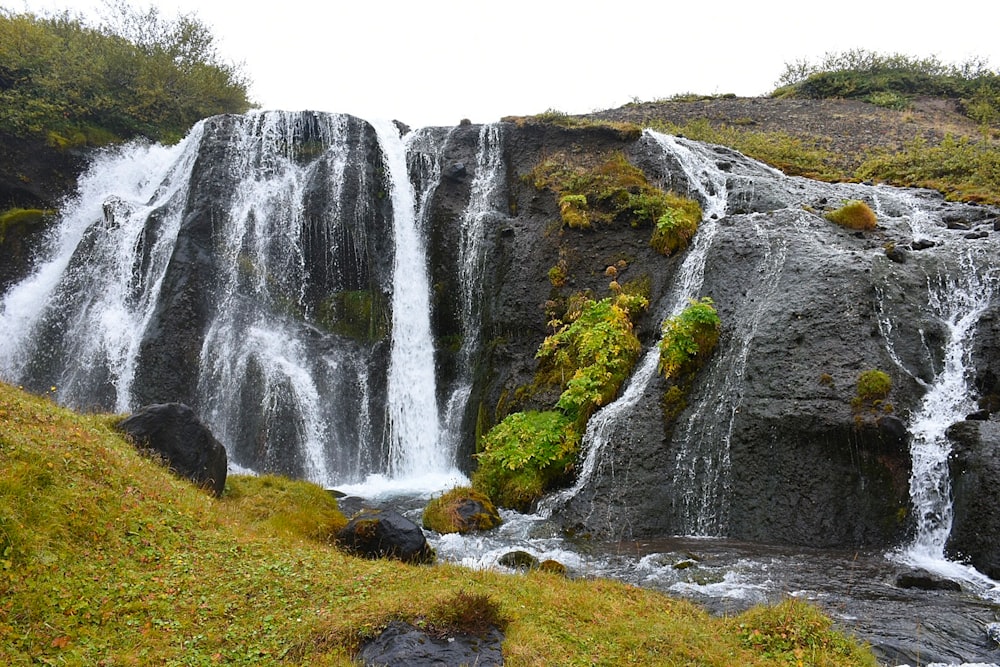 a large waterfall with water cascading down it's sides