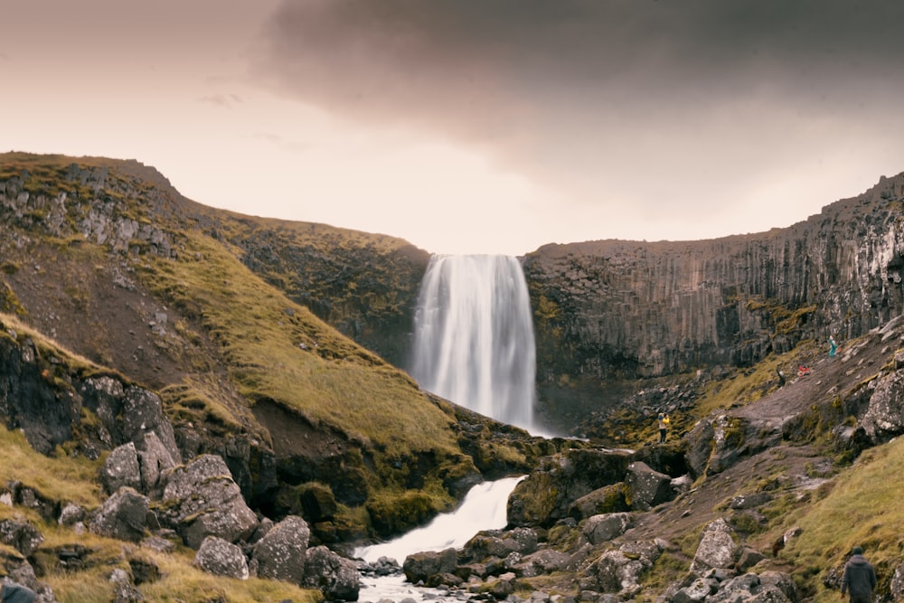 a waterfall in the middle of a valley