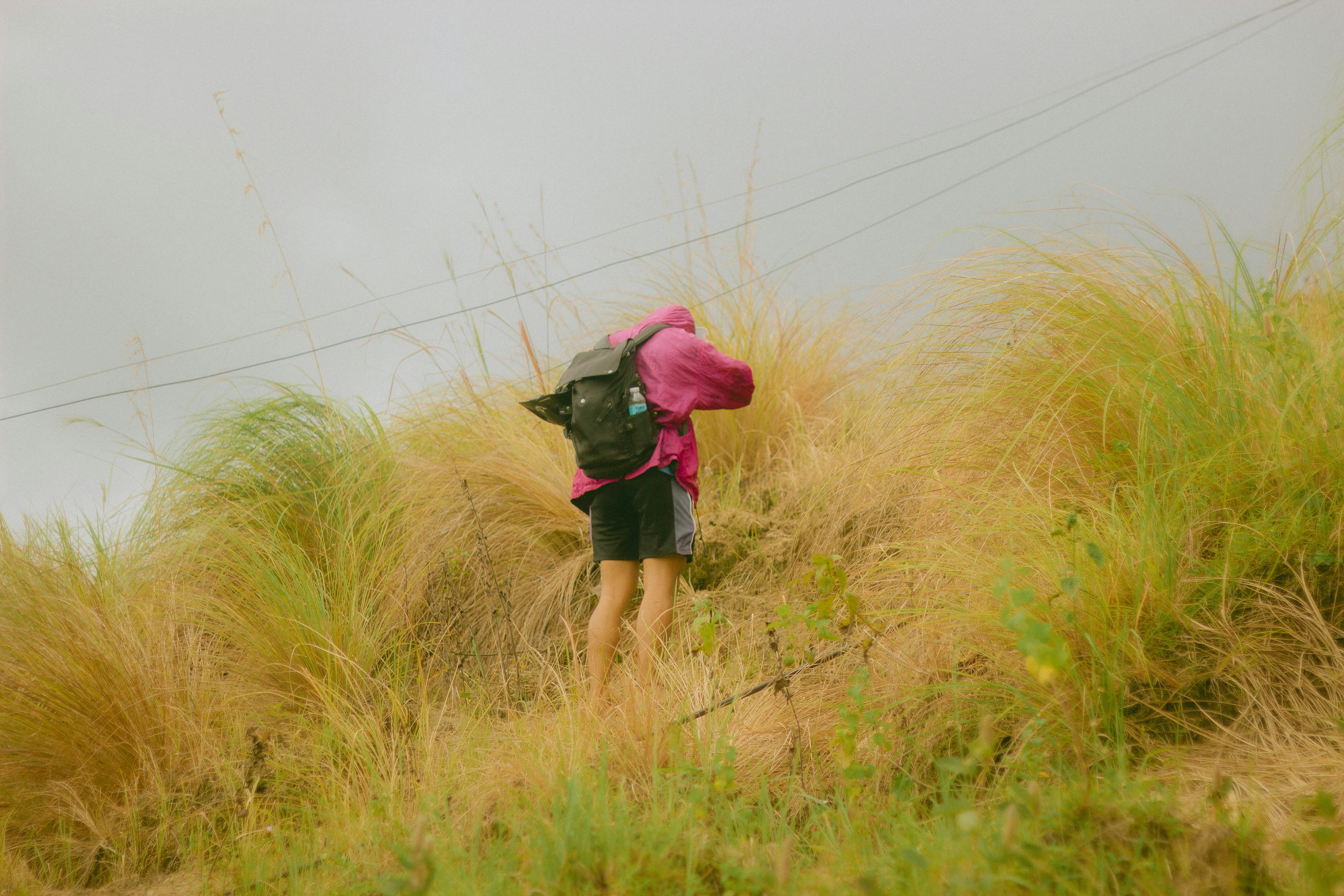 a person walking up a hill with a backpack