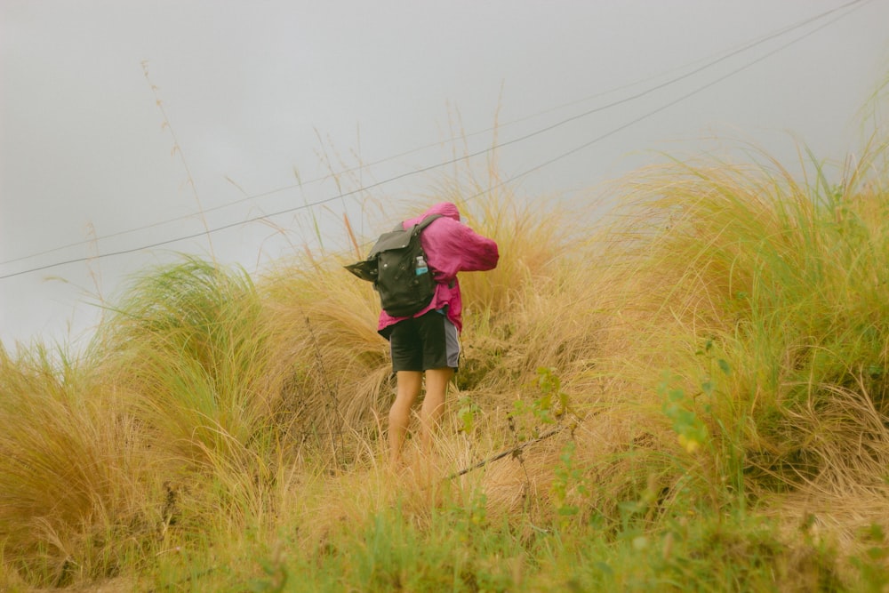 a person walking up a hill with a backpack