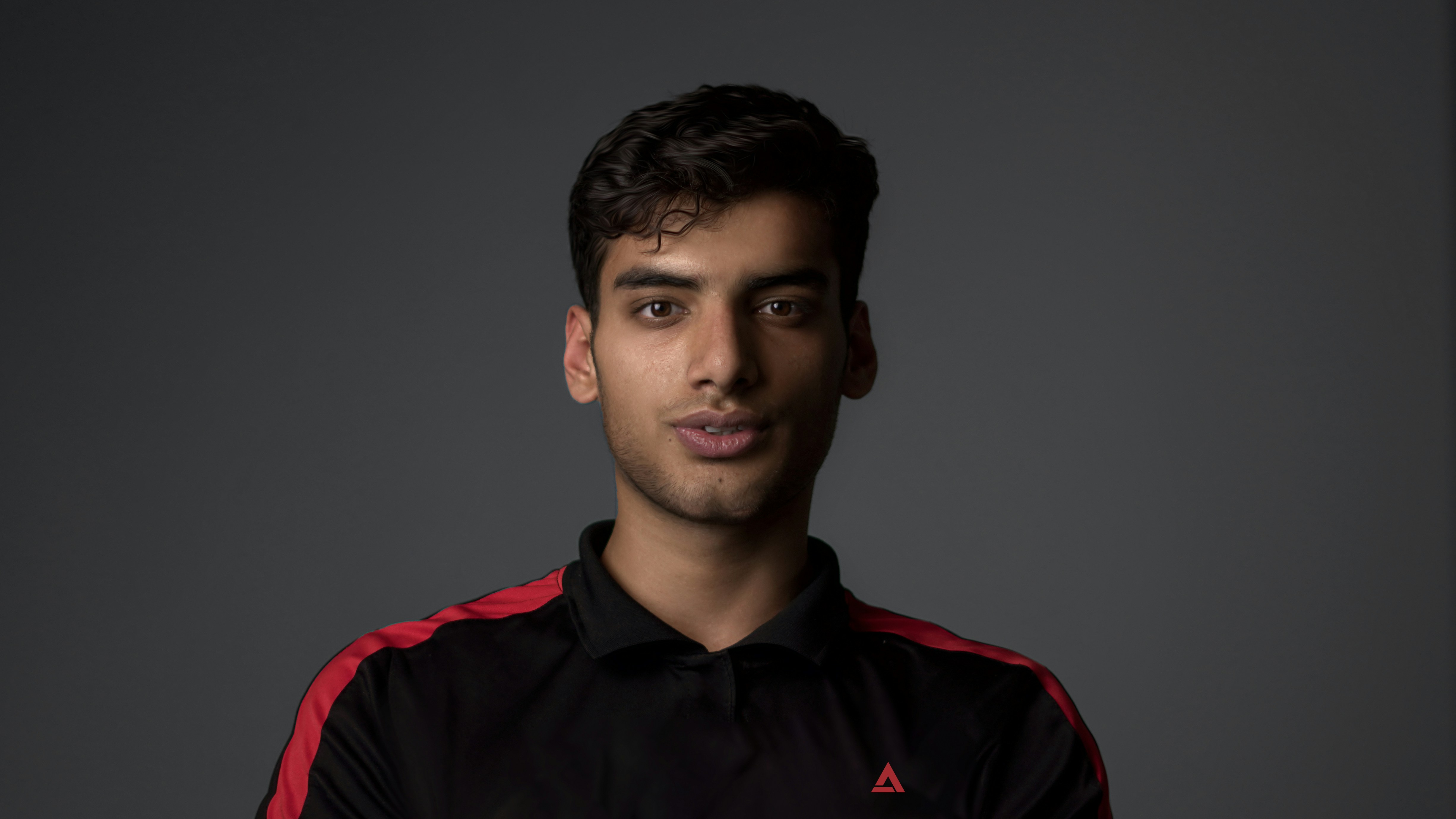 a man in a black and red shirt posing for a picture