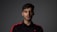 a man in a black and red shirt posing for a picture