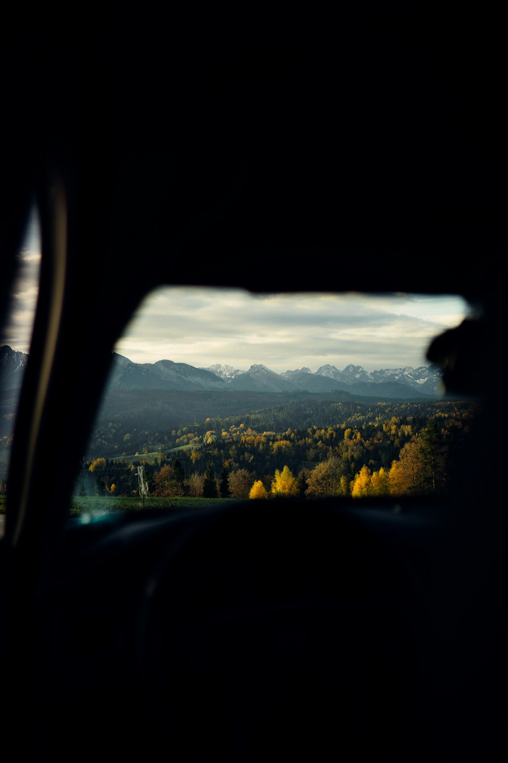 a view of a mountain range from a car window