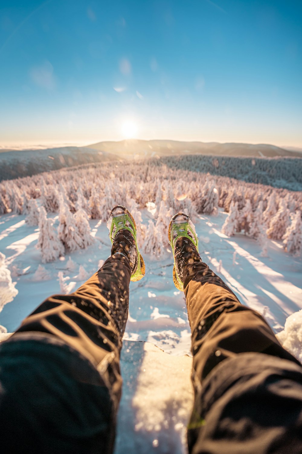 a person standing on top of a snow covered slope