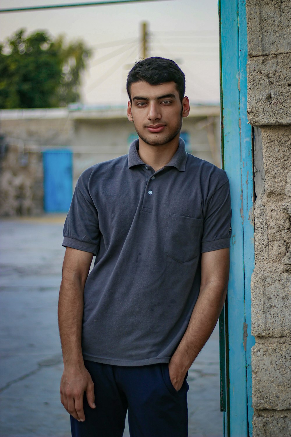 a man standing in front of a blue door