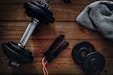 a pair of dumbbells, a towel and a pair of dumbbells