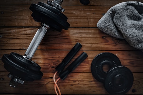 a pair of dumbbells, a towel and a pair of dumbbells