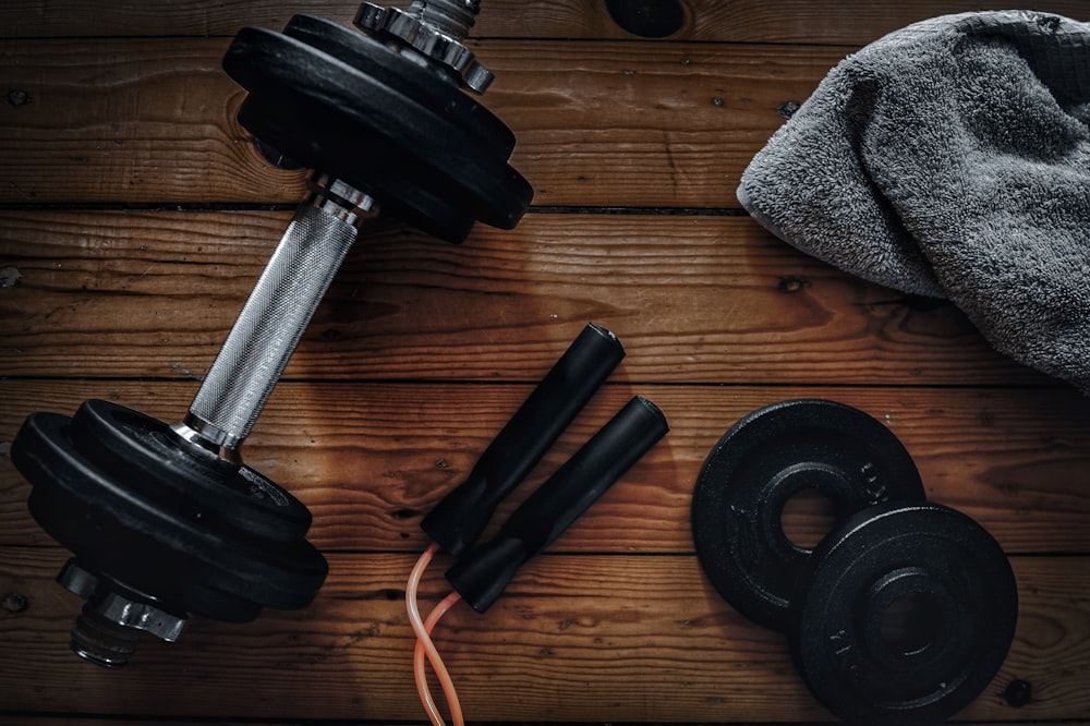 a pair of dumbbells, a towel and a pair of dumbbells
