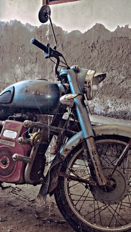 A vintage motorcycle displayed in a rustic garage.