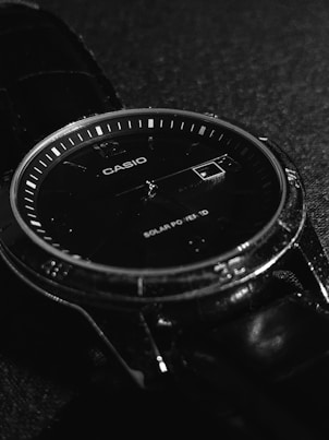 a close up of a watch on a black surface