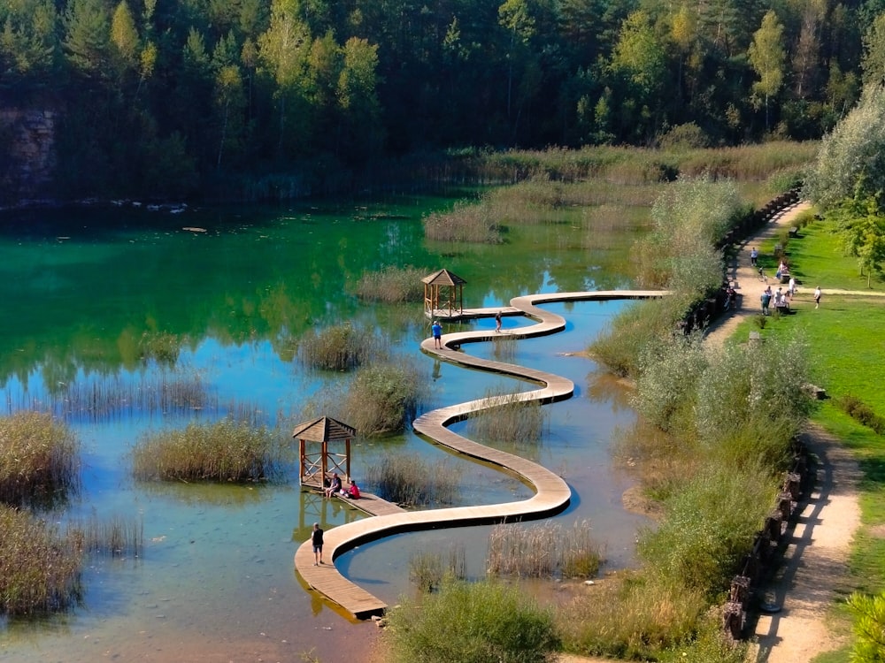 a lake with a wooden walkway going through it